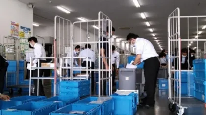 写真:物流センター内に置いて社員がコロナ関連商材の荷造りをしている様子